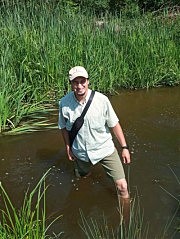 Олег Дьяков демонстрирует уровень воды в реке